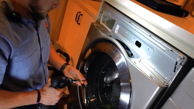 Local appliance repair technician servicing a washer drain pump